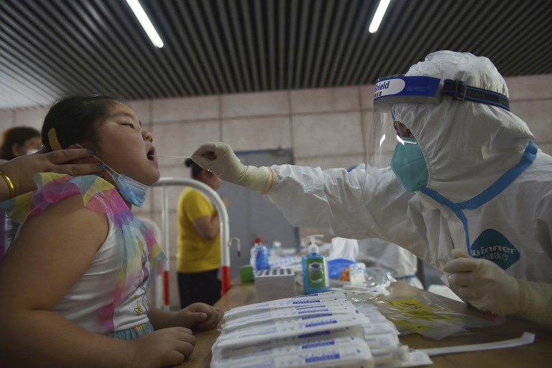Virus Outbreak China Residents rush to stock up on necessities at a supermarket after authorities lockdown near residential blocks to prevent the spread of the COVID-19 in Wuhan city in central China's Hubei province Monday, Aug. 2, 2021. Chinese authorities announced Tuesday the mass testing of Wuhan as an unusually wide series of COVID-19 outbreaks reached the city where the disease was first detected in late 2019. (Chinatopix via AP)