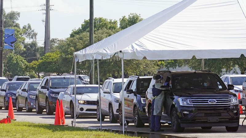 Cars line up at Miami Dade College North campus' COVID-19 testing site, Thursday, July 29, 2021, in Miami. Hospital admissions of coronavirus patients continue to soar in Florida with at least two areas in the state surpassing previous peaks reached during last summer's surge. (AP Photo/Marta Lavandier)