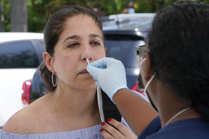 Virus Outbreak Florida Cars line up at Miami Dade College North campus' COVID-19 testing site, Thursday, July 29, 2021, in Miami. Hospital admissions of coronavirus patients continue to soar in Florida with at least two areas in the state surpassing previous peaks reached during last summer's surge. (AP Photo/Marta Lavandier)