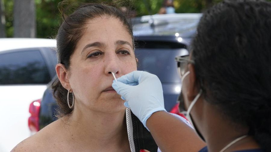 Cars line up at Miami Dade College North campus' COVID-19 testing site, Thursday, July 29, 2021, in Miami. Hospital admissions of coronavirus patients continue to soar in Florida with at least two areas in the state surpassing previous peaks reached during last summer's surge. (AP Photo/Marta Lavandier)