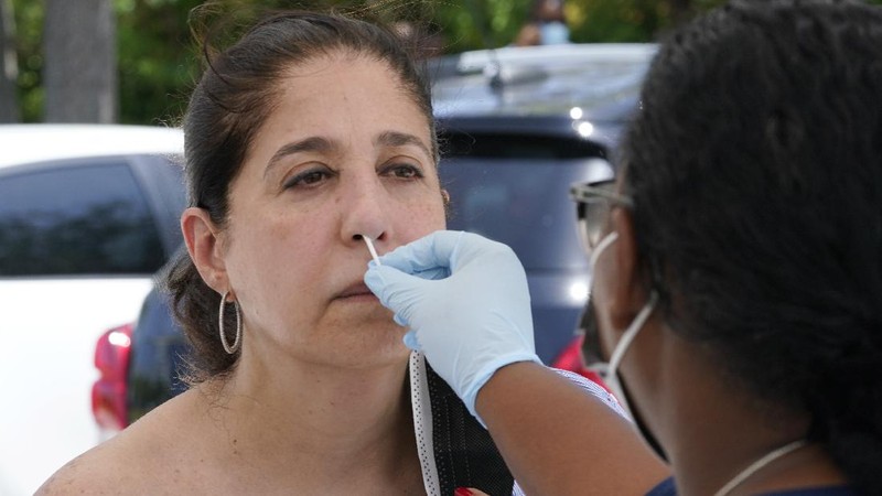 Cars line up at Miami Dade College North campus' COVID-19 testing site, Thursday, July 29, 2021, in Miami. Hospital admissions of coronavirus patients continue to soar in Florida with at least two areas in the state surpassing previous peaks reached during last summer's surge. (AP Photo/Marta Lavandier)