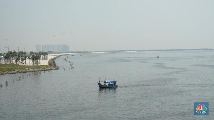 Suasana pantai pasir putih di Kawasan PIK 2, Dadap, Tangerang, Banten, Rabu (4/8/2021). Pantai Pasir Putih di kawasan Pantai Indah Kapuk tengah populer di kalangan traveler. Semenjak dibuka tahun 2020 lalu, tak sedikit traveler yang singgah ke Pantai Pasir Putih kala bertandang ke PIK. Di tengah kondisi pandemi, destinasi outdoor ini memang jadi primadona. Kini sejak diberlakukan PPKM darurat level 4 terlihat kawasan pasir putih sepi pengunjung. Hanya beberapa perahu nelayan yang sedang mencari  ikan di perairan laut pasir putih. Apabila PIK pertama berada di Provinsi DKI Jakarta, maka Pantai Pasir Putih di PIK2 masuk ke Provinsi Banten. (CNBC Indonesia/ Muhammad Sabki)