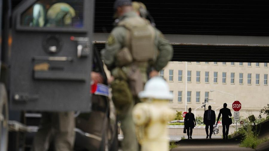 Armored police are seen outside the Pentagon, Tuesday, Aug. 3, 2021 at the Pentagon in Washington. Gunshots were fired Tuesday morning near the entrance of the Pentagon, resulting in multiple injuries. The facility, the headquarters of the U.S. military, was temporarily placed on lockdown. The Arlington County Fire Department reported “multiple patients,” but it wasn't immediately clear if they had been shot and the extent of their injuries were unknown. (AP Photo/Andrew Harnik)