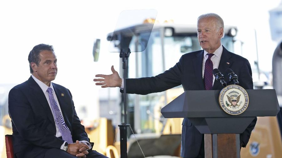 While New York Gov. Andrew Cuomo, left, looks on, Vice President Joe Biden speaks during a news conference at LaGuardia Airport in New York, Tuesday, June 14, 2016. Cuomo and Biden were helping to announce and break ground on major infrastructure improvements at the airport. (AP Photo/Seth Wenig)
