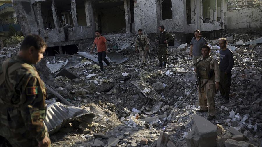 Afghan security personnel stand guard following an attack in Kabul, Afghanistan, Wednesday, Aug. 4, 2021. A powerful explosion rocked an upscale neighborhood of Afghanistan's capital Tuesday in an attack that apparently targeted the country's acting defense minister. (AP Photo/Rahmat Gul)