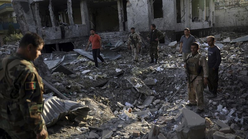 Afghan security personnel stand guard following an attack in Kabul, Afghanistan, Wednesday, Aug. 4, 2021. A powerful explosion rocked an upscale neighborhood of Afghanistan's capital Tuesday in an attack that apparently targeted the country's acting defense minister. (AP Photo/Rahmat Gul)
