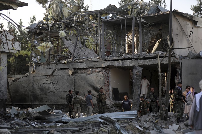 Afghan security personnel stand guard following an attack in Kabul, Afghanistan, Wednesday, Aug. 4, 2021. A powerful explosion rocked an upscale neighborhood of Afghanistan's capital Tuesday in an attack that apparently targeted the country's acting defense minister. (AP Photo/Rahmat Gul)
