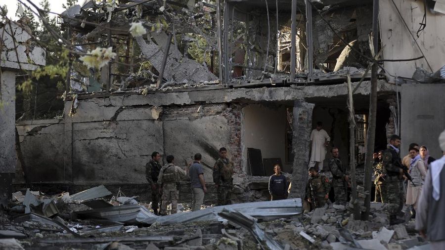 Afghan security personnel stand guard following an attack in Kabul, Afghanistan, Wednesday, Aug. 4, 2021. A powerful explosion rocked an upscale neighborhood of Afghanistan's capital Tuesday in an attack that apparently targeted the country's acting defense minister. (AP Photo/Rahmat Gul)