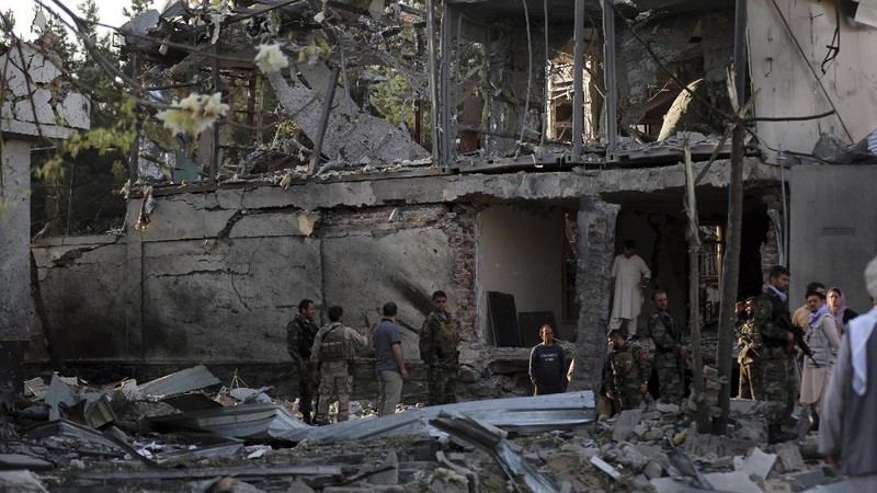 Afghan security personnel stand guard following an attack in Kabul, Afghanistan, Wednesday, Aug. 4, 2021. A powerful explosion rocked an upscale neighborhood of Afghanistan's capital Tuesday in an attack that apparently targeted the country's acting defense minister. (AP Photo/Rahmat Gul)