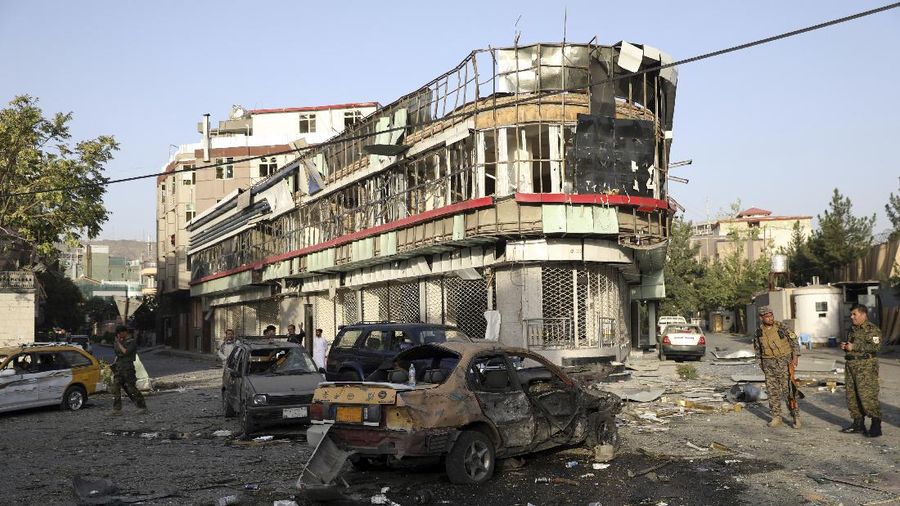 Afghan security personnel stand guard following an attack in Kabul, Afghanistan, Wednesday, Aug. 4, 2021. A powerful explosion rocked an upscale neighborhood of Afghanistan's capital Tuesday in an attack that apparently targeted the country's acting defense minister. (AP Photo/Rahmat Gul)