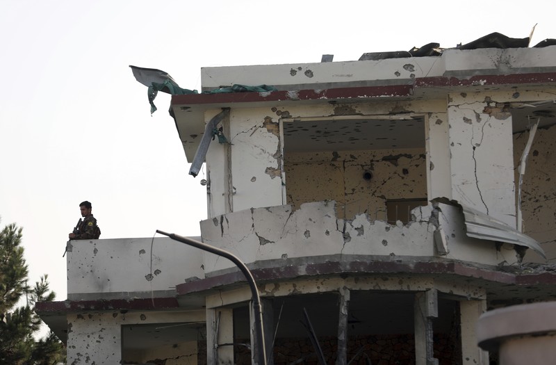 Afghan security personnel stand guard following an attack in Kabul, Afghanistan, Wednesday, Aug. 4, 2021. A powerful explosion rocked an upscale neighborhood of Afghanistan's capital Tuesday in an attack that apparently targeted the country's acting defense minister. (AP Photo/Rahmat Gul)