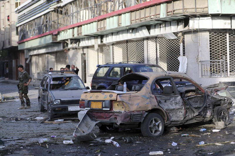Afghan security personnel stand guard following an attack in Kabul, Afghanistan, Wednesday, Aug. 4, 2021. A powerful explosion rocked an upscale neighborhood of Afghanistan's capital Tuesday in an attack that apparently targeted the country's acting defense minister. (AP Photo/Rahmat Gul)