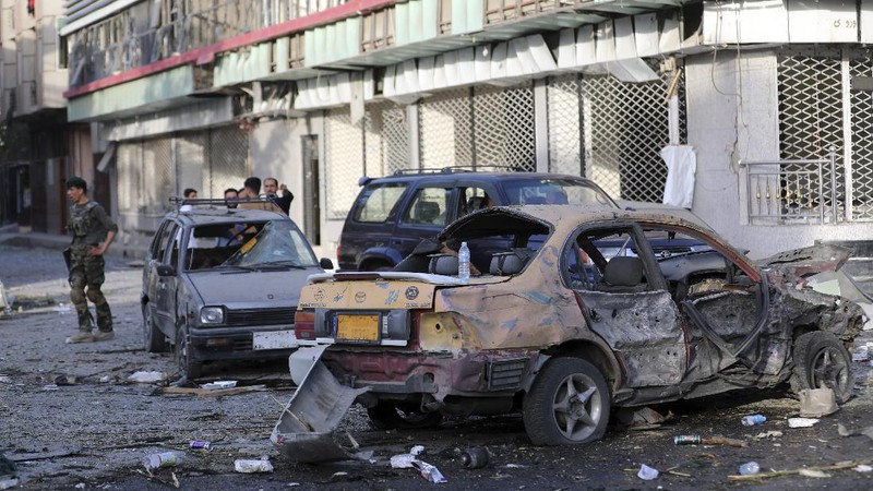 Afghan security personnel stand guard following an attack in Kabul, Afghanistan, Wednesday, Aug. 4, 2021. A powerful explosion rocked an upscale neighborhood of Afghanistan's capital Tuesday in an attack that apparently targeted the country's acting defense minister. (AP Photo/Rahmat Gul)