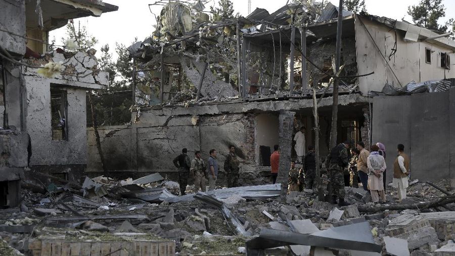 Afghan security personnel stand guard following an attack in Kabul, Afghanistan, Wednesday, Aug. 4, 2021. A powerful explosion rocked an upscale neighborhood of Afghanistan's capital Tuesday in an attack that apparently targeted the country's acting defense minister. (AP Photo/Rahmat Gul)