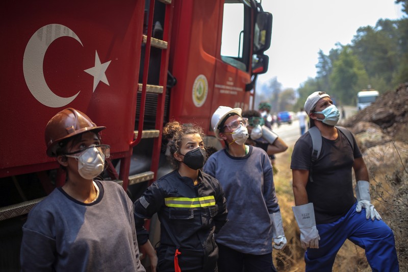 Turkish volunteers head to fight wildfires in Turgut village, near tourist resort of Marmaris, Mugla, Turkey, Wednesday, Aug. 4, 2021. As Turkish fire crews pressed ahead Tuesday with their weeklong battle against blazes tearing through forests and villages on the country's southern coast, President Recep Tayyip Erdogan's government faced increased criticism over its apparent poor response and inadequate preparedness for large-scale wildfires.(AP Photo/Emre Tazegul)