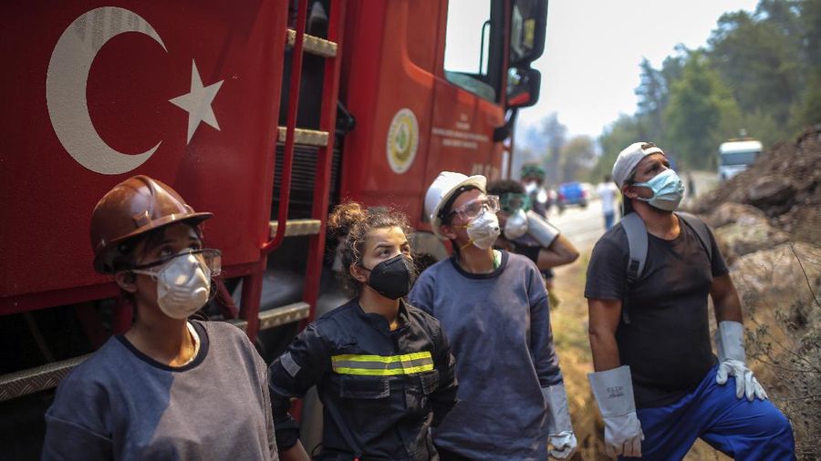 Turkish volunteers head to fight wildfires in Turgut village, near tourist resort of Marmaris, Mugla, Turkey, Wednesday, Aug. 4, 2021. As Turkish fire crews pressed ahead Tuesday with their weeklong battle against blazes tearing through forests and villages on the country's southern coast, President Recep Tayyip Erdogan's government faced increased criticism over its apparent poor response and inadequate preparedness for large-scale wildfires.(AP Photo/Emre Tazegul)