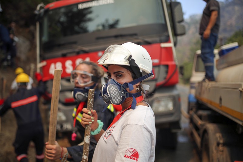 Turkey Wildfires Turkish volunteers head to fight wildfires in Turgut village, near tourist resort of Marmaris, Mugla, Turkey, Wednesday, Aug. 4, 2021. As Turkish fire crews pressed ahead Tuesday with their weeklong battle against blazes tearing through forests and villages on the country's southern coast, President Recep Tayyip Erdogan's government faced increased criticism over its apparent poor response and inadequate preparedness for large-scale wildfires.(AP Photo/Emre Tazegul)