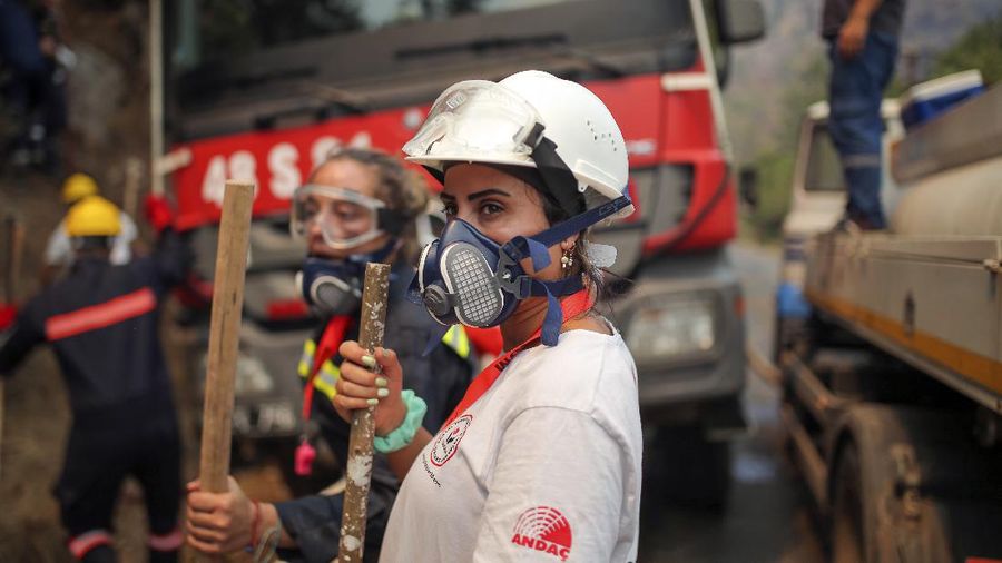Turkish volunteers head to fight wildfires in Turgut village, near tourist resort of Marmaris, Mugla, Turkey, Wednesday, Aug. 4, 2021. As Turkish fire crews pressed ahead Tuesday with their weeklong battle against blazes tearing through forests and villages on the country's southern coast, President Recep Tayyip Erdogan's government faced increased criticism over its apparent poor response and inadequate preparedness for large-scale wildfires.(AP Photo/Emre Tazegul)