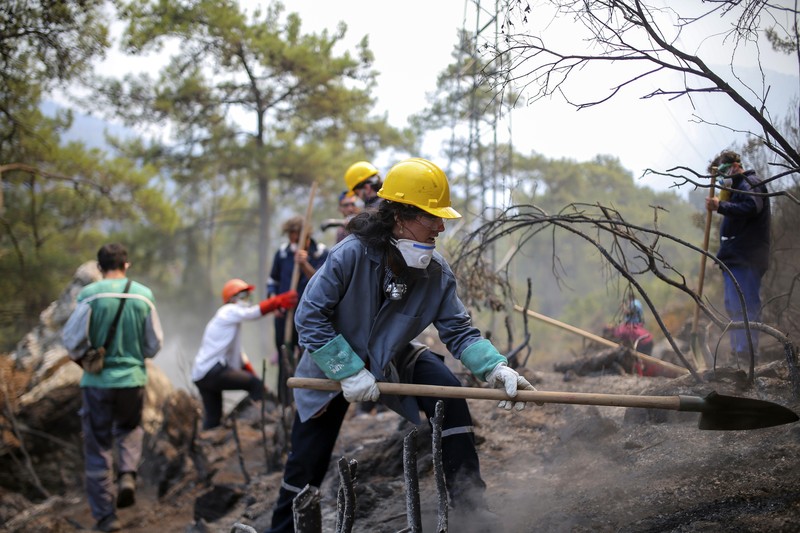 Turkey Wildfires Turkish volunteers head to fight wildfires in Turgut village, near tourist resort of Marmaris, Mugla, Turkey, Wednesday, Aug. 4, 2021. As Turkish fire crews pressed ahead Tuesday with their weeklong battle against blazes tearing through forests and villages on the country's southern coast, President Recep Tayyip Erdogan's government faced increased criticism over its apparent poor response and inadequate preparedness for large-scale wildfires.(AP Photo/Emre Tazegul)