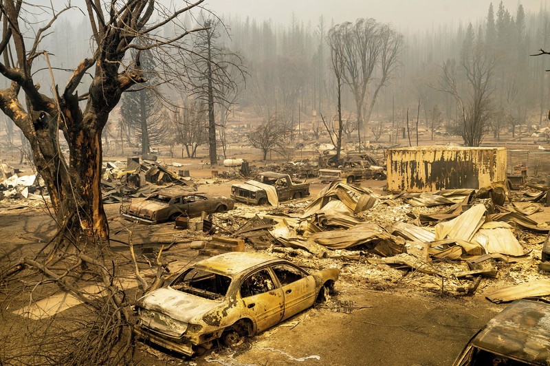 Flames from the Dixie Fire consume a pickup truck on Highway 89 south of Greenville on Thursday, Aug. 5, 2021, in Plumas County, Calif. (AP Photo/Noah Berger)