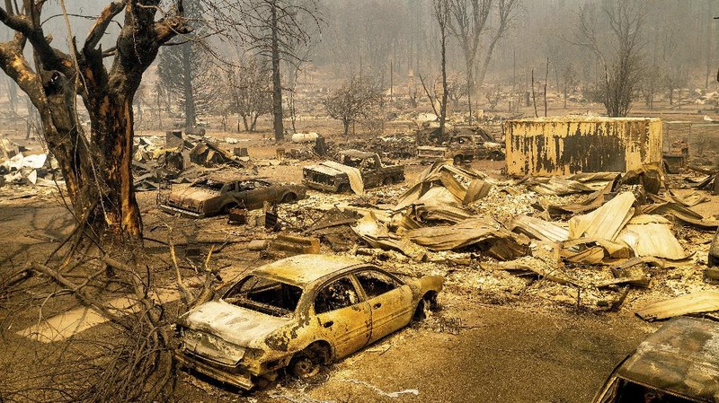 Flames from the Dixie Fire consume a pickup truck on Highway 89 south of Greenville on Thursday, Aug. 5, 2021, in Plumas County, Calif. (AP Photo/Noah Berger)
