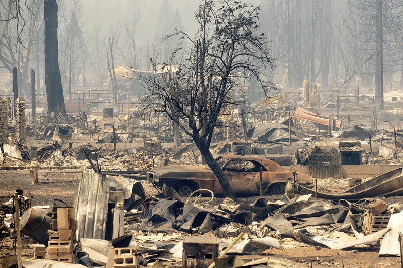 California Wildfires Flames from the Dixie Fire consume a pickup truck on Highway 89 south of Greenville on Thursday, Aug. 5, 2021, in Plumas County, Calif. (AP Photo/Noah Berger)