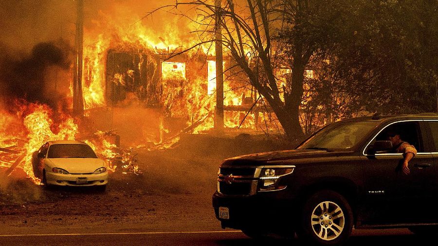 Flames from the Dixie Fire consume a pickup truck on Highway 89 south of Greenville on Thursday, Aug. 5, 2021, in Plumas County, Calif. (AP Photo/Noah Berger)