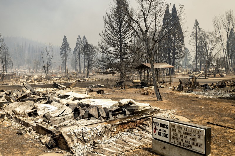 California Wildfires Flames from the Dixie Fire consume a pickup truck on Highway 89 south of Greenville on Thursday, Aug. 5, 2021, in Plumas County, Calif. (AP Photo/Noah Berger)