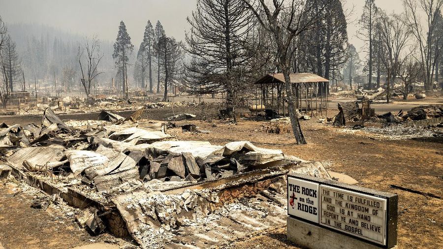 Flames from the Dixie Fire consume a pickup truck on Highway 89 south of Greenville on Thursday, Aug. 5, 2021, in Plumas County, Calif. (AP Photo/Noah Berger)