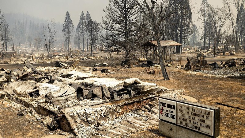 Flames from the Dixie Fire consume a pickup truck on Highway 89 south of Greenville on Thursday, Aug. 5, 2021, in Plumas County, Calif. (AP Photo/Noah Berger)