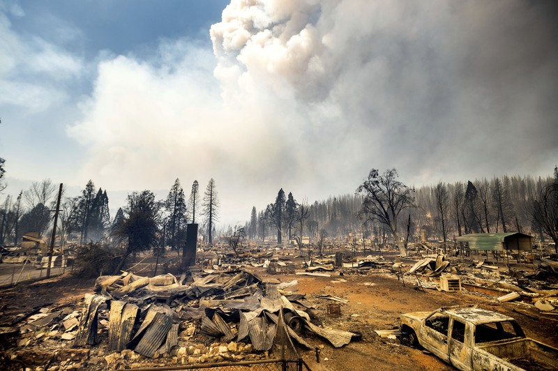 California Wildfires Flames from the Dixie Fire consume a pickup truck on Highway 89 south of Greenville on Thursday, Aug. 5, 2021, in Plumas County, Calif. (AP Photo/Noah Berger)