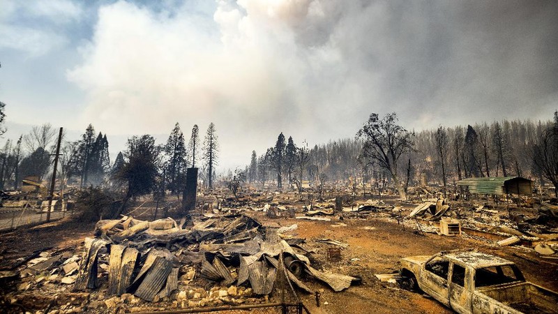 Flames from the Dixie Fire consume a pickup truck on Highway 89 south of Greenville on Thursday, Aug. 5, 2021, in Plumas County, Calif. (AP Photo/Noah Berger)