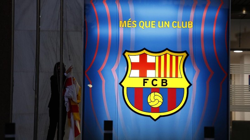 A fan wearing the number 10 Lionel Messi replica shirt sits outside the club offices with others in Barcelona, Spain, Thursday, Aug. 5, 2021. Barcelona announced Thursday that Messi will not stay with the club, saying that the Spanish league's financial regulations made it impossible to sign the Argentina star to a new contract. (AP Photo/Joan Monfort)