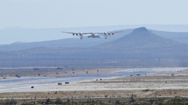 Special guests chat as they wait for Virgin Galactic founder Richard Branson's launch to space aboard his own rocket ship near Truth or Consequences, New Mexico, Sunday, July 11, 2021. (AP Photo/Andres Leighton)