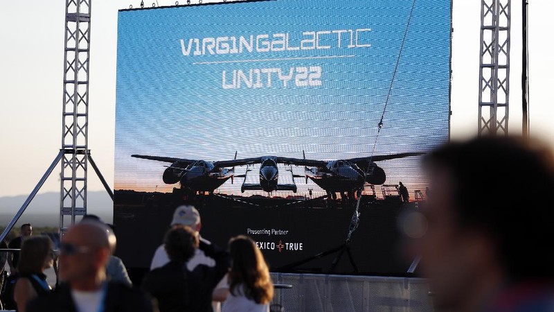 Special guests chat as they wait for Virgin Galactic founder Richard Branson's launch to space aboard his own rocket ship near Truth or Consequences, New Mexico, Sunday, July 11, 2021. (AP Photo/Andres Leighton)