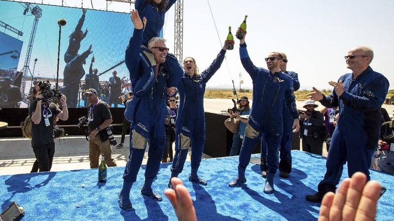 Special guests chat as they wait for Virgin Galactic founder Richard Branson's launch to space aboard his own rocket ship near Truth or Consequences, New Mexico, Sunday, July 11, 2021. (AP Photo/Andres Leighton)