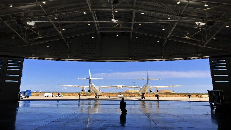 Special guests chat as they wait for Virgin Galactic founder Richard Branson's launch to space aboard his own rocket ship near Truth or Consequences, New Mexico, Sunday, July 11, 2021. (AP Photo/Andres Leighton)