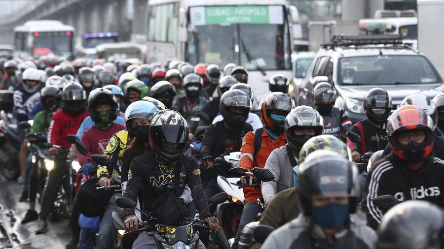 Motorists queue at a checkpoint during a stricter lockdown as a precaution against the spread of the new coronavirus disease at the outskirts of Marikina City, Philippines on Friday, August 6, 2021. Thousands of people jammed coronavirus vaccination centers in the Philippine capital, defying social distancing restrictions, after false news spread that unvaccinated residents would be deprived of cash aid or barred from leaving home during a two-week lockdown that started Friday. (AP Photo/Basilio Sepe)