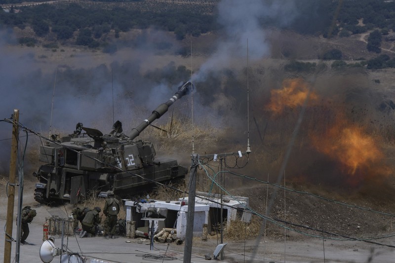 Israeli forces fire artillery from their position on the border with Lebanon after a barrage of rockets were fired from Lebanon, Friday, Aug. 6, 2021. The militant Hezbollah group said it fired rockets near Israeli positions close to the Lebanese border, calling it retaliation for Israeli airstrikes on southern Lebanon a day earlier. (Ayal Margolin/JINIPIX via AP)