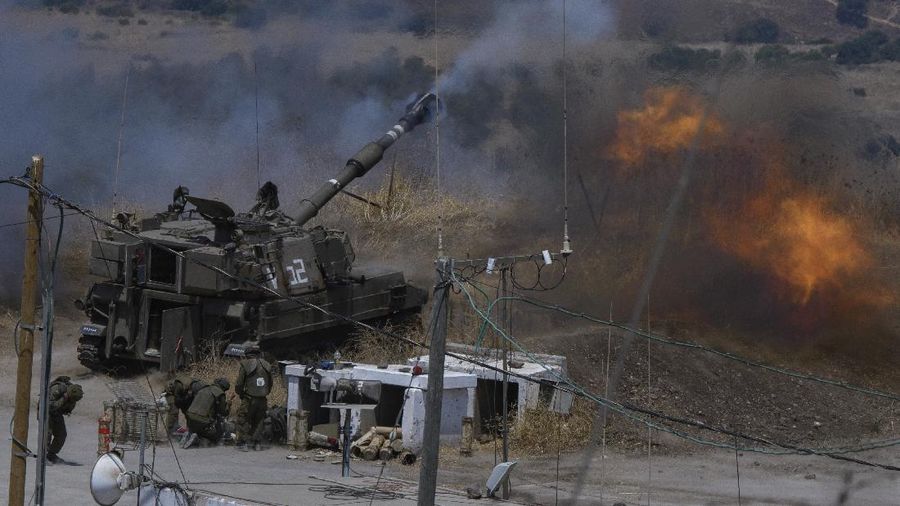 Israeli forces fire artillery from their position on the border with Lebanon after a barrage of rockets were fired from Lebanon, Friday, Aug. 6, 2021. The militant Hezbollah group said it fired rockets near Israeli positions close to the Lebanese border, calling it retaliation for Israeli airstrikes on southern Lebanon a day earlier. (Ayal Margolin/JINIPIX via AP)