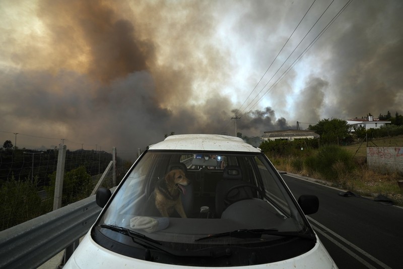 Flames burn on the mountain near Limni village on the island of Evia, about 160 kilometers (100 miles) north of Athens, Greece, Tuesday, Aug. 3, 2021. Greece Tuesday grappled with the worst heatwave in decades that strained the national power supply and fueled wildfires near Athens and elsewhere in southern Greece. As the heat wave scorching the eastern Mediterranean intensified, temperatures reached 42 degrees Celsius (107.6 Fahrenheit) in parts of the Greek capital. (AP Photo/Michael Pappas)