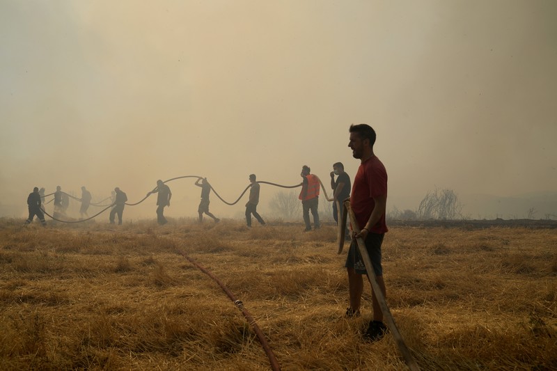 Flames burn on the mountain near Limni village on the island of Evia, about 160 kilometers (100 miles) north of Athens, Greece, Tuesday, Aug. 3, 2021. Greece Tuesday grappled with the worst heatwave in decades that strained the national power supply and fueled wildfires near Athens and elsewhere in southern Greece. As the heat wave scorching the eastern Mediterranean intensified, temperatures reached 42 degrees Celsius (107.6 Fahrenheit) in parts of the Greek capital. (AP Photo/Michael Pappas)