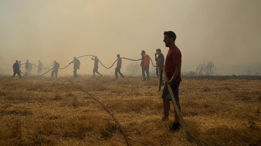 Flames burn on the mountain near Limni village on the island of Evia, about 160 kilometers (100 miles) north of Athens, Greece, Tuesday, Aug. 3, 2021. Greece Tuesday grappled with the worst heatwave in decades that strained the national power supply and fueled wildfires near Athens and elsewhere in southern Greece. As the heat wave scorching the eastern Mediterranean intensified, temperatures reached 42 degrees Celsius (107.6 Fahrenheit) in parts of the Greek capital. (AP Photo/Michael Pappas)