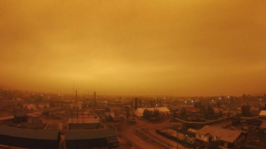 FILE - In this file photo taken on Monday, Aug. 2, 2021, Smoke from forest fires is seen over small town of Kysyl-Syr, Vilyuysky District, Sakha Republic also known as Yakutia, Russia Far East. Wildfires in Russia's vast Siberia region are endangering several villages and prompted evacuations and other emergency precautions. Officials said 93 active forest fires burned across 1.1 million hectares (2.8 million acres) of Sakha-Yakutia in northeastern Siberia. (AP Photo/Nikolay Petrov, File)