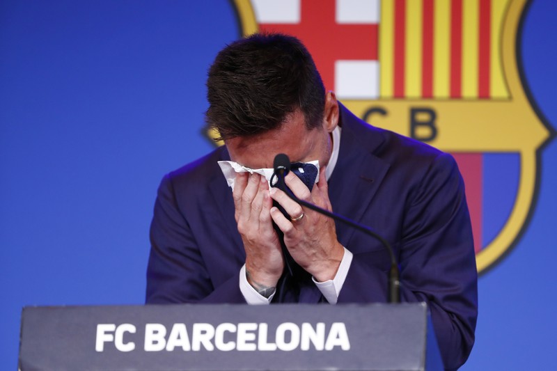 Spain Soccer Barcelona Messi Lionel Messi cries at the start of a press conference at the Camp Nou stadium in Barcelona, Spain, Sunday, Aug. 8, 2021. FC Barcelona had previously announced the negotiations with Lionel Messi had ended and that Messi would be leaving the club. (AP Photo/Joan Monfort)