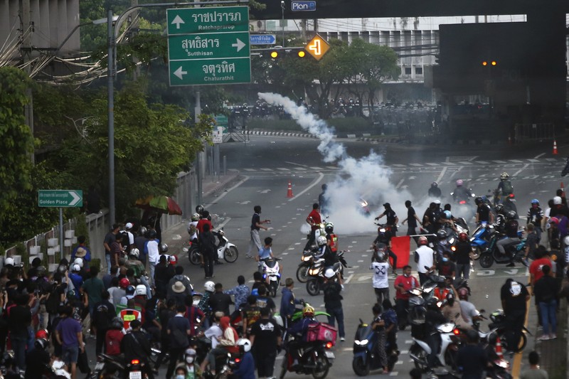 Thailand Protests Riot police launch tear gas to anti-government protesters during a protest in Bangkok, Thailand, Saturday, Aug. 7, 2021. Protesters demanded the resignation of Prime Minister Prayuth Chan-ocha and for part of the budget for the monarchy and the military to be redirected into the fight against the coronavirus. Many people blame Prayuth and his administration for failing to develop an adequate vaccination policy. (AP Photo/Anuthep Cheysakron)