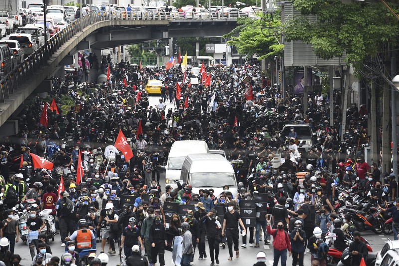 Riot police launch tear gas to anti-government protesters during a protest in Bangkok, Thailand, Saturday, Aug. 7, 2021. Protesters demanded the resignation of Prime Minister Prayuth Chan-ocha and for part of the budget for the monarchy and the military to be redirected into the fight against the coronavirus. Many people blame Prayuth and his administration for failing to develop an adequate vaccination policy. (AP Photo/Anuthep Cheysakron)