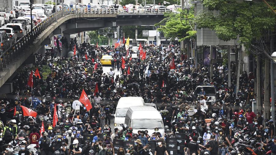 Riot police launch tear gas to anti-government protesters during a protest in Bangkok, Thailand, Saturday, Aug. 7, 2021. Protesters demanded the resignation of Prime Minister Prayuth Chan-ocha and for part of the budget for the monarchy and the military to be redirected into the fight against the coronavirus. Many people blame Prayuth and his administration for failing to develop an adequate vaccination policy. (AP Photo/Anuthep Cheysakron)
