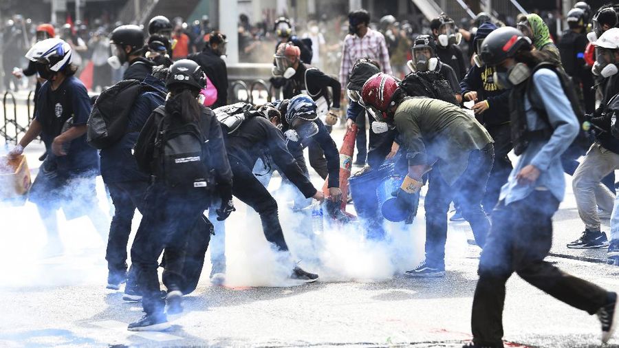 Riot police launch tear gas to anti-government protesters during a protest in Bangkok, Thailand, Saturday, Aug. 7, 2021. Protesters demanded the resignation of Prime Minister Prayuth Chan-ocha and for part of the budget for the monarchy and the military to be redirected into the fight against the coronavirus. Many people blame Prayuth and his administration for failing to develop an adequate vaccination policy. (AP Photo/Anuthep Cheysakron)