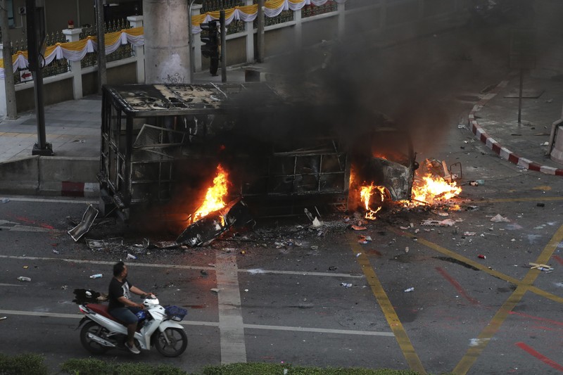Riot police launch tear gas to anti-government protesters during a protest in Bangkok, Thailand, Saturday, Aug. 7, 2021. Protesters demanded the resignation of Prime Minister Prayuth Chan-ocha and for part of the budget for the monarchy and the military to be redirected into the fight against the coronavirus. Many people blame Prayuth and his administration for failing to develop an adequate vaccination policy. (AP Photo/Anuthep Cheysakron)